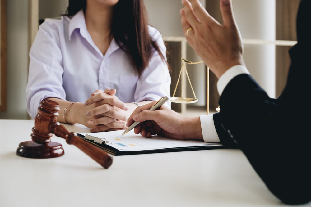 An attorney reviews a case with a client